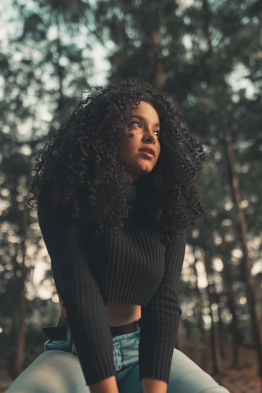 Ethnic woman sitting in nature